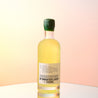 A bottle of limoncello on sunset and blue studio background.