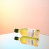 A bottle of coffee liqueur on a sunset orange gradient studio background.